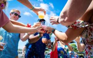 A group of happy people cheering with beer and wine