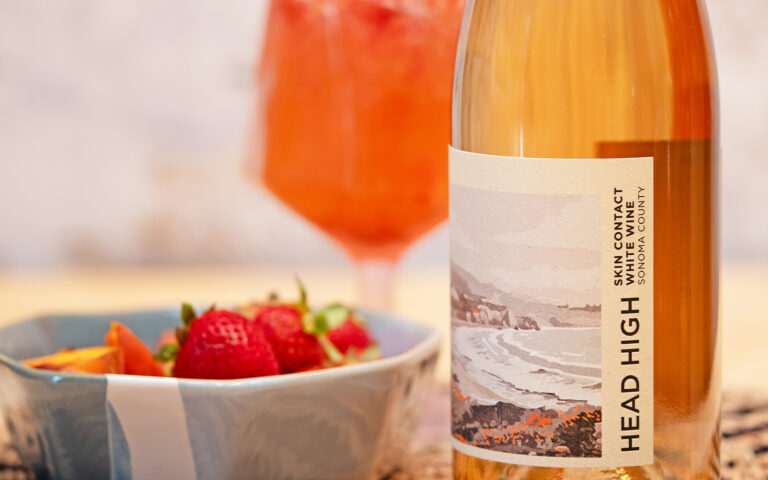 picture of wine bottle with fresh berries and peaches